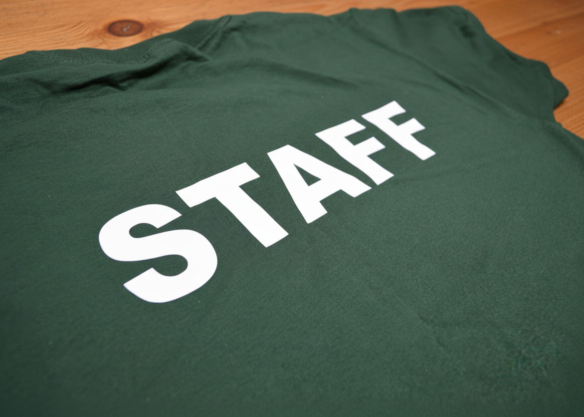 Green shirt with 'STAFF' printed in white on a plain background